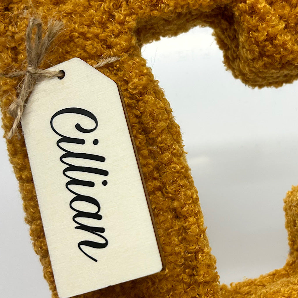 Bouclé fabric letter with wooden swingtag