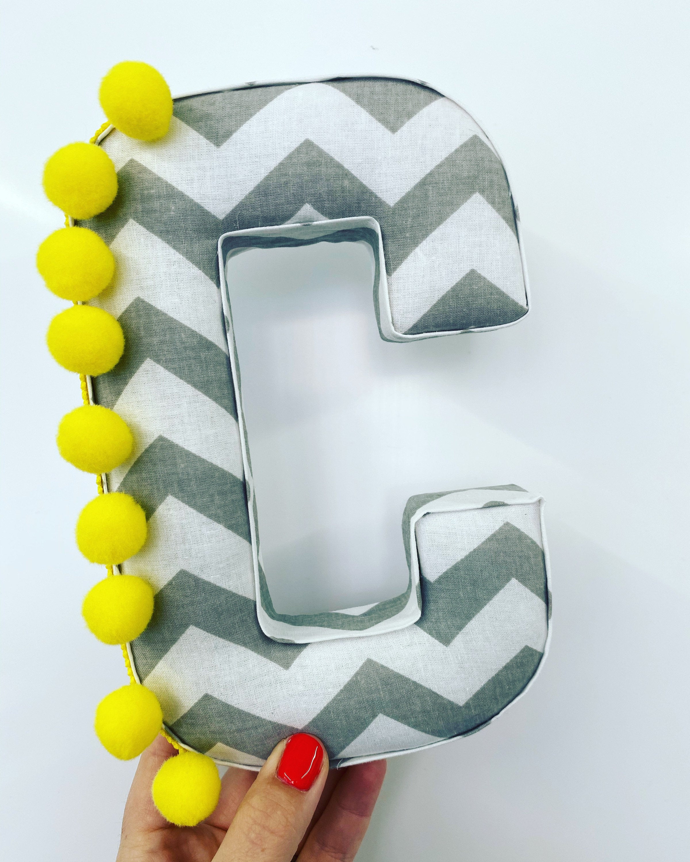 Grey and white pompom fabric letter yellow