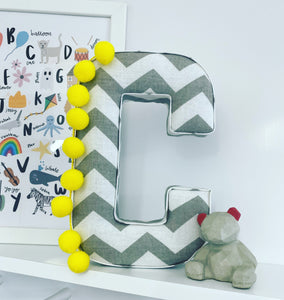 Grey and white pompom fabric letter yellow
